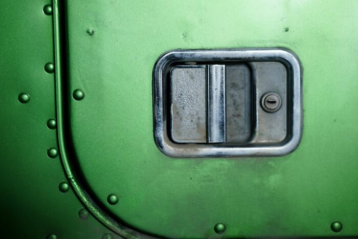 A green car door handle, a detail that might lead to unhinged questions from cabin crew to passengers.