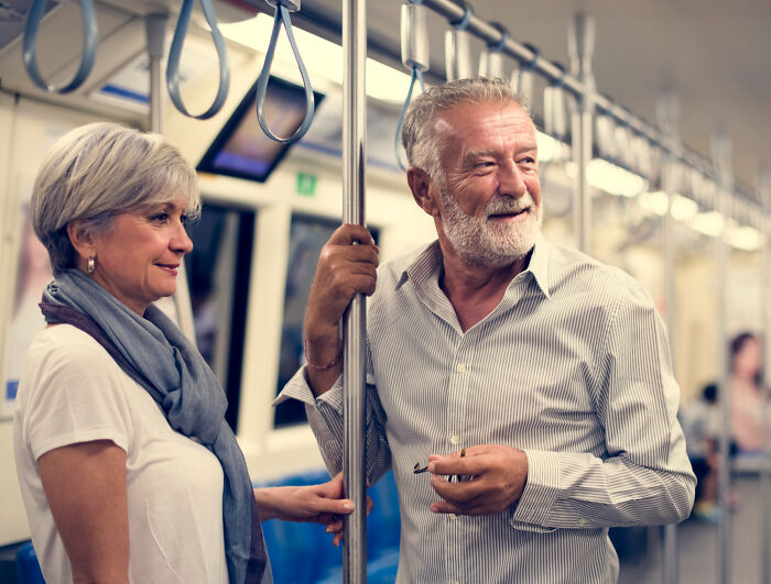 Cabin crew questions: Older couple riding subway, perhaps discussing questions asked by cabin crew.