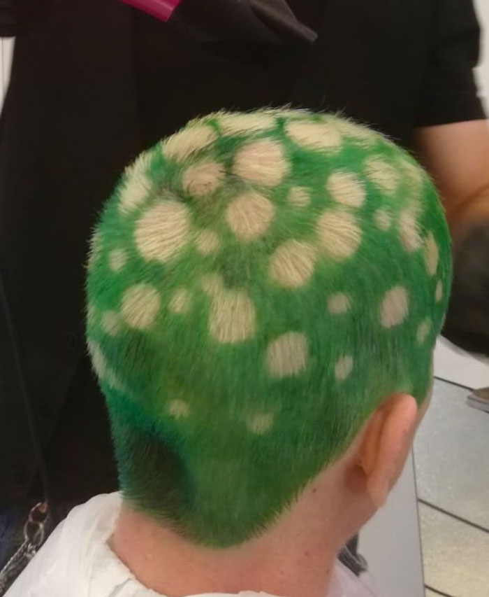 A person with bright green hair and white polka dots, an example of bold hairstyles.