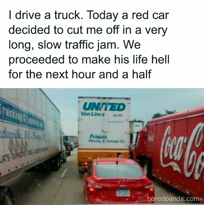 A red car stuck between two large trucks in a traffic jam, perfectly demonstrating how people got back at someone.