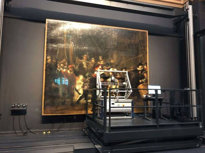 An old painting being scanned by modern equipment, showing how trips didn't go as planned for restoration.