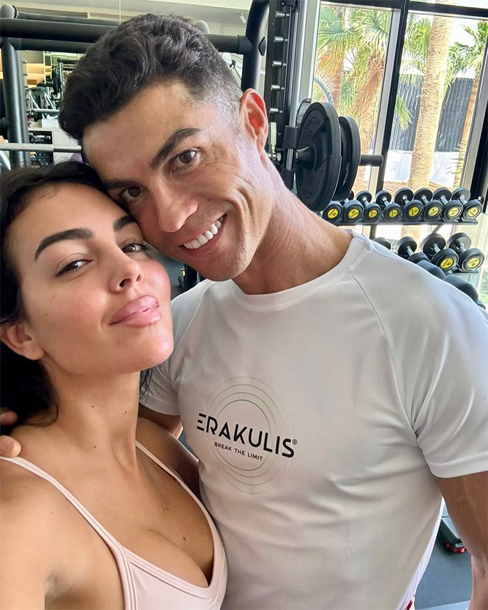 Georgina Rodriguez and Cristiano Ronaldo smiling in a gym, confident amidst yacht photos and body-shamer comments.