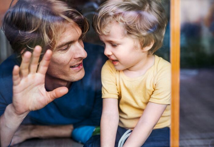 A father and young child look at each other through a window, discussing horrible parent behaviors.