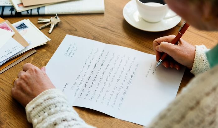 A person writing a letter with a pen, picking up a skill in 30 days that genuinely changed their life.