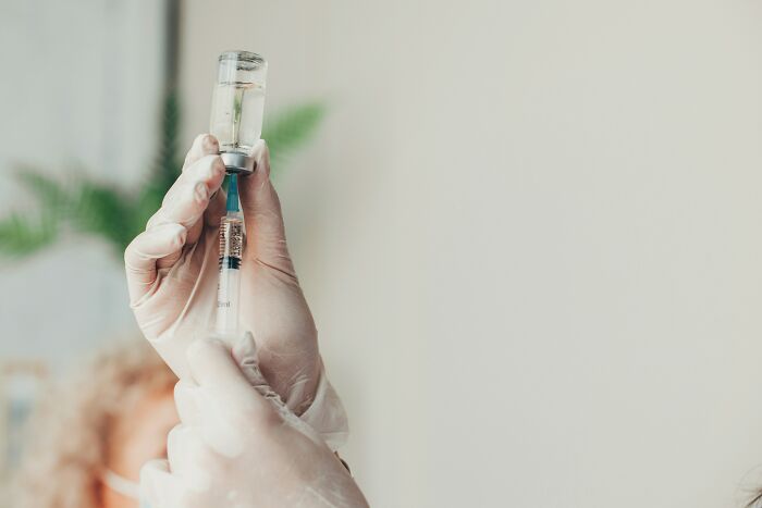 Medical professional preparing a syringe, highlighting misconceptions surrounding health and vaccinations.