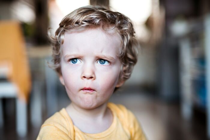 A young child with a worried expression, illustrating a child with a horrible parent.