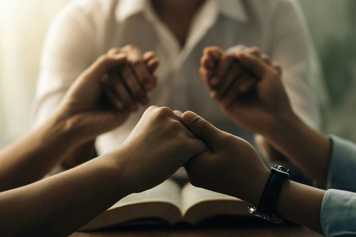 Hands clasped in prayer over an open book, reflecting on the afterlife after a man's heart stopped during surgery. Hands clasped in prayer over an open book, reflecting on the afterlife after a man's heart stopped during surgery.