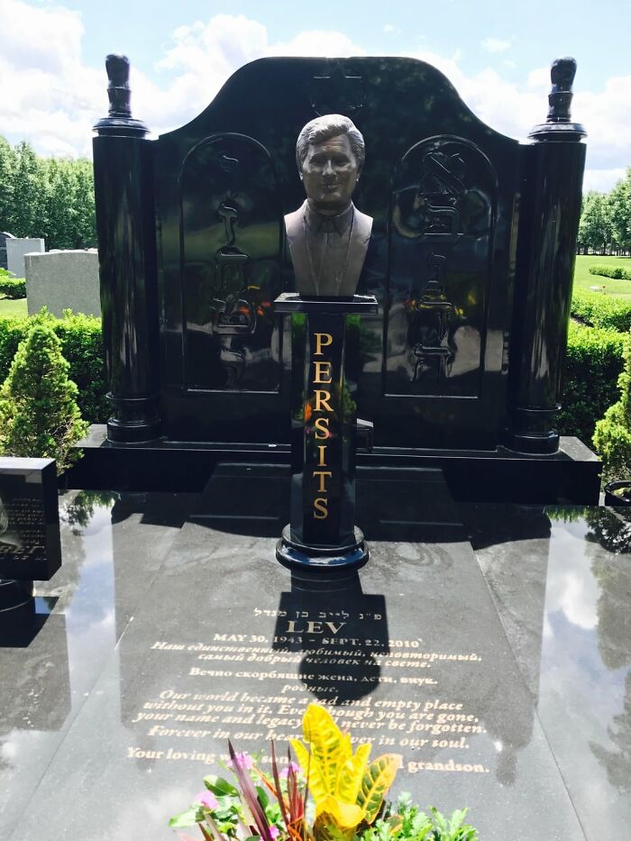 A bust on a tombstone in a cemetery, revealing a secret of a person's life.