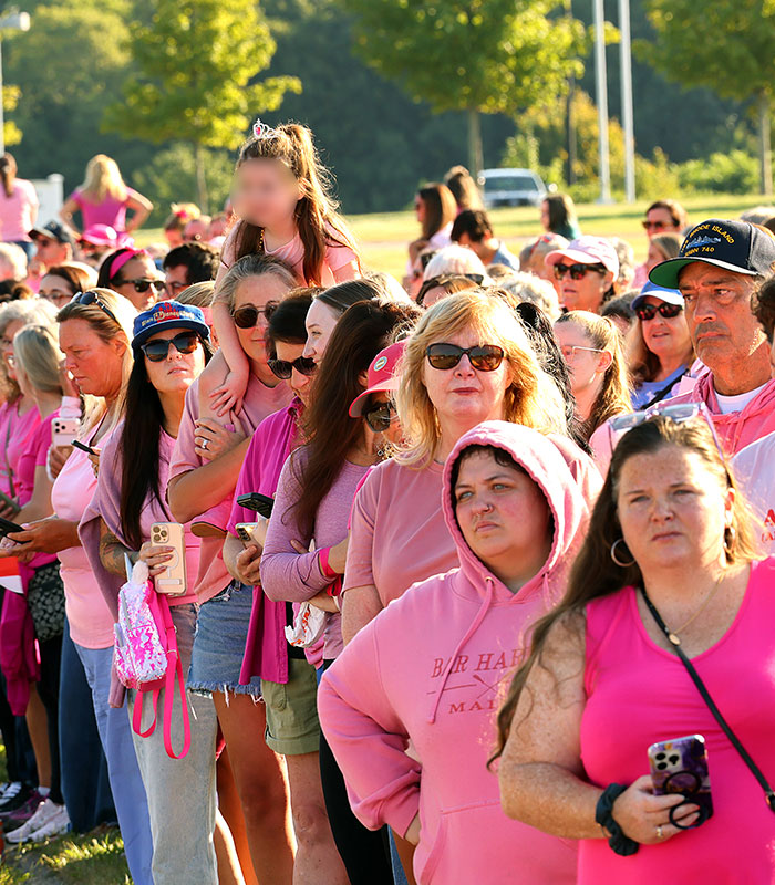 People gather in a crowd, many wearing pink, supporting Lindsay Clancy during her trial. People gather in a crowd, many wearing pink, supporting Lindsay Clancy during her trial.