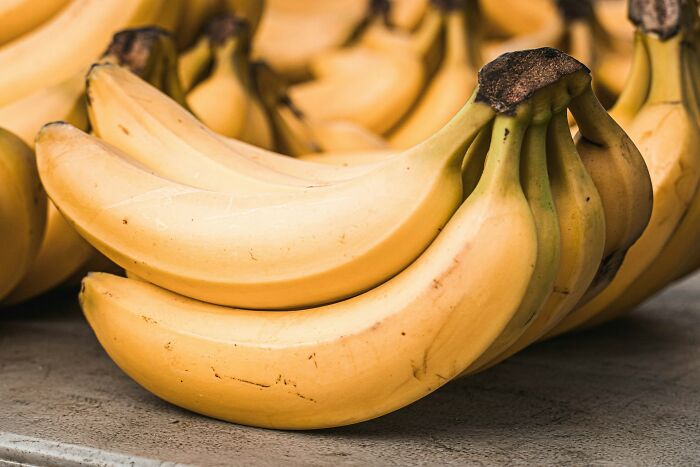 Questionable Instacart shoppers with a bunch of bananas, possibly mishandling produce.