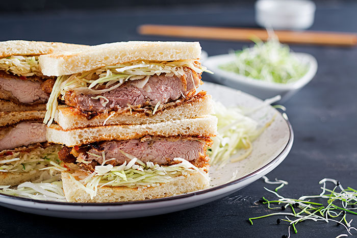 A delicious katsu sando sandwich with crispy pork cutlet and shredded cabbage, a harmless secret to warm your heart.