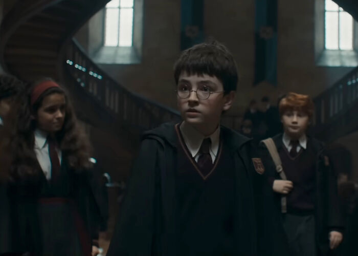 Young Harry Potter fan in Hogwarts robes, showing the impact of Harry Potter fans on an undersea cable.