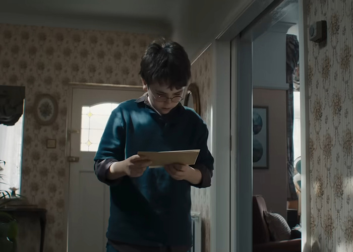 Harry Potter fan looking at an envelope, prompting authorities to reroute an undersea cable.