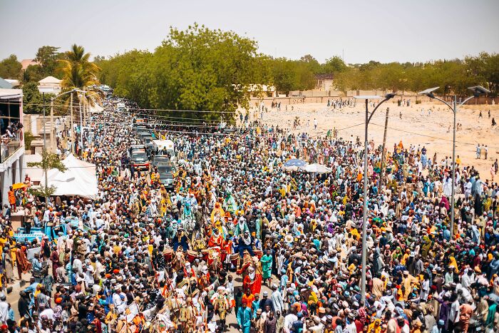 A massive crowd of people on a street, an example of how harmless-looking things can be dangerous.