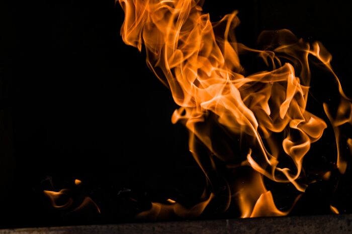 Flames dancing in the dark, bright orange and yellow. Harmless-looking things can be dangerous.