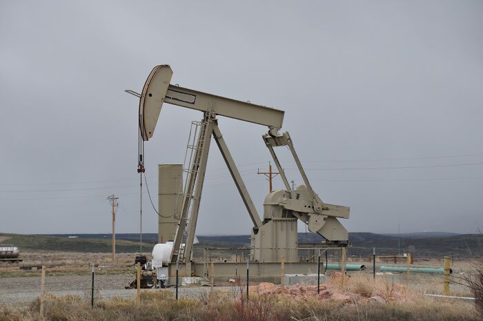 An oil pumpjack in a barren landscape; a harmless-looking thing that can be dangerous.