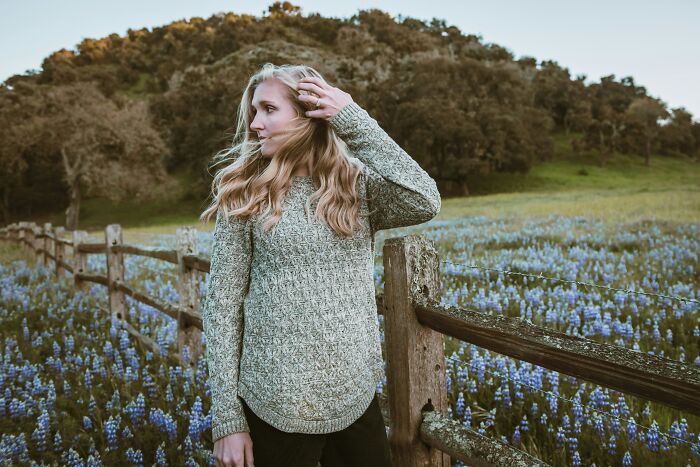 A young woman in a field of flowers, recalling weird encounters with American tourists.