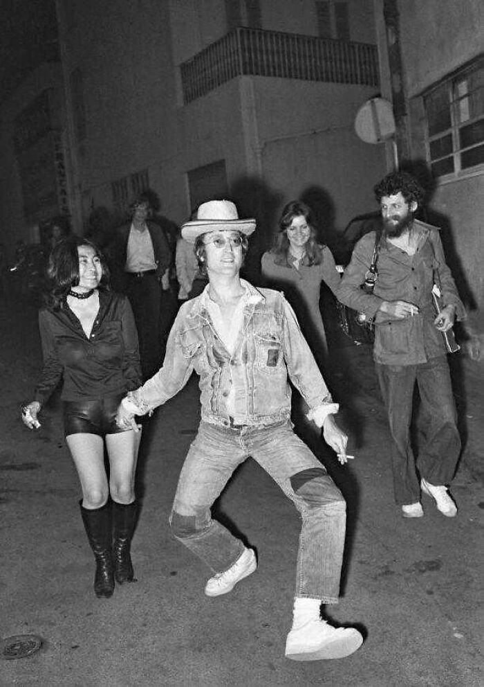 British humor with a person wearing a denim jacket and a hat, holding hands with a woman.