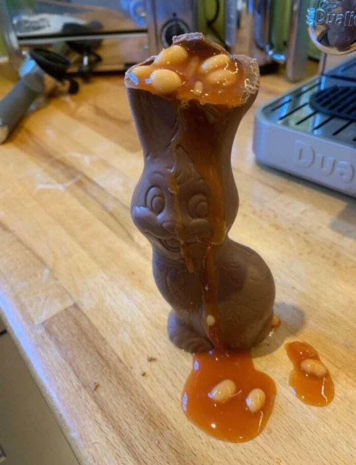Chocolate bunny filled with baked beans and caramel sauce, displaying dry British humor.