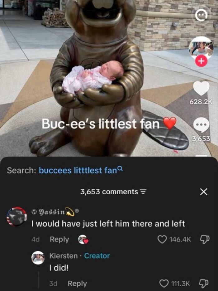 A tiny baby rests in the arms of a Buc-ee statue, captioned Buc-ee's littlest fan. A funny meme.