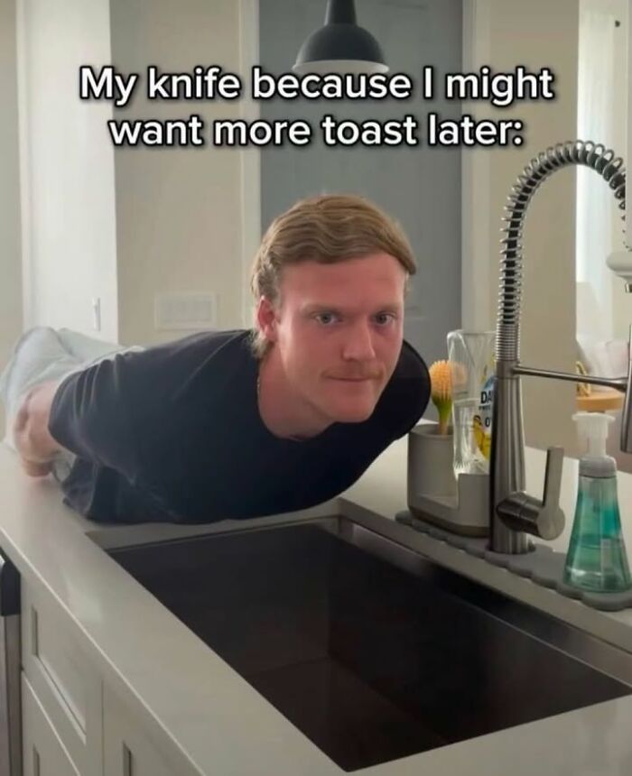 A man poses on a kitchen counter in a funny meme, highlighting life distractions with humor.
