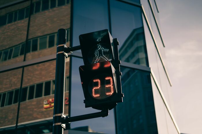 A traffic light displaying a walking person and the number 23, an absurd and hilarious firsthand sighting.