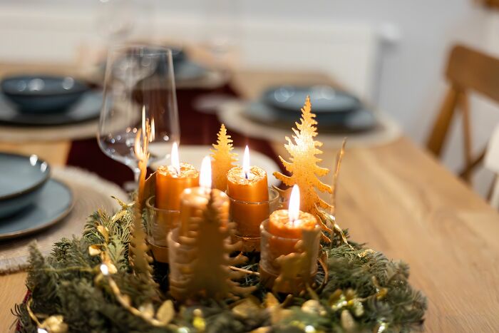 An advent wreath with lit candles and festive decorations. A firsthand witnessed beautiful setup, perhaps with absurd details.