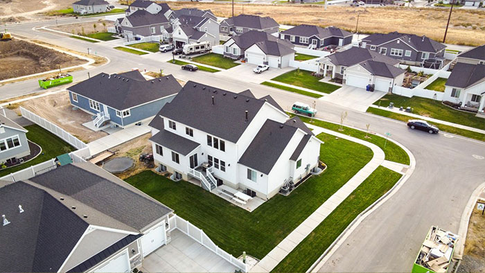 An aerial view of a new neighborhood, showing houses near a resident's property, involved in an HOA secret scheme.