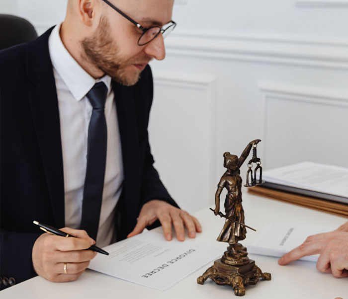 A lawyer reviewing documents, related to an HOA's secret scheme and not leaving a resident alone.