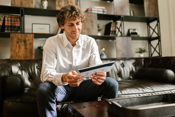 A resident receiving mail, looking at documents after the HOA won't leave him alone.