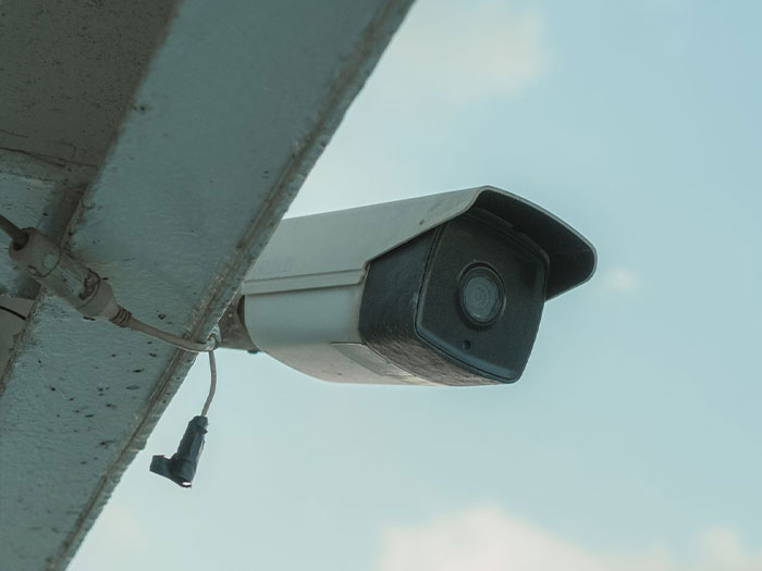 A security camera positioned under an overhang, part of a resident's efforts after the HOA won't leave them alone.