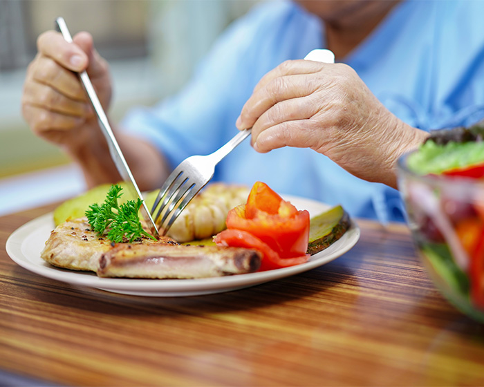 A person in a hospital gown eating a meal, discussing Hollywood Star's extreme food habits and doctor intervention. A person in a hospital gown eating a meal, discussing Hollywood Star's extreme food habits and doctor intervention.