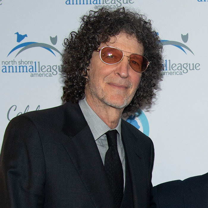 Howard Stern at an event, a figure tied to Dolly Parton feuds and controversies.