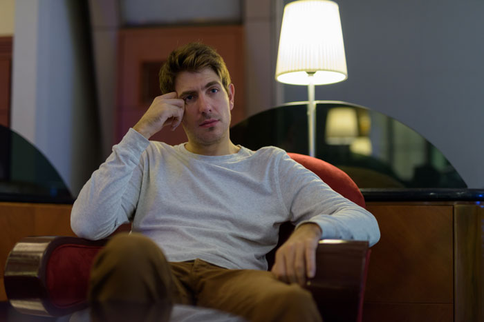 A man with a serious expression, representing a husband dealing with his poly wife and best friend. A man with a serious expression, representing a husband dealing with his poly wife and best friend.