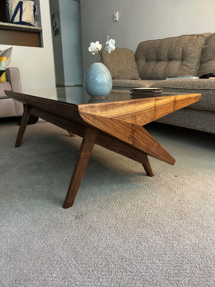 A modern, custom-built wooden coffee table, an example of a brilliant DIY home project for a transformed space.