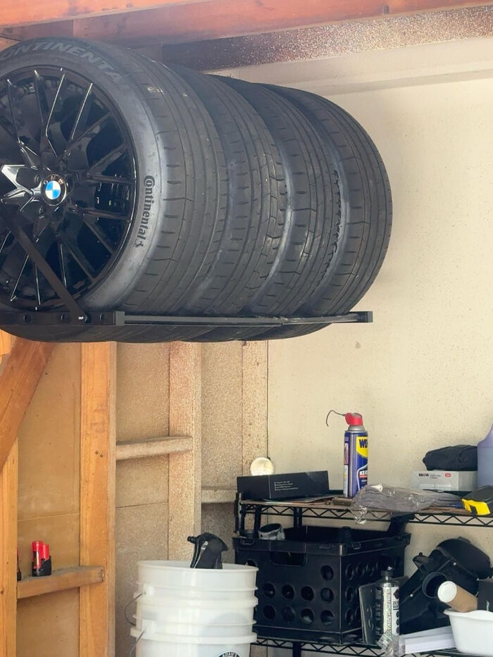 A DIY home project: tires stored on an overhead rack in a garage, showcasing clever space transformation.