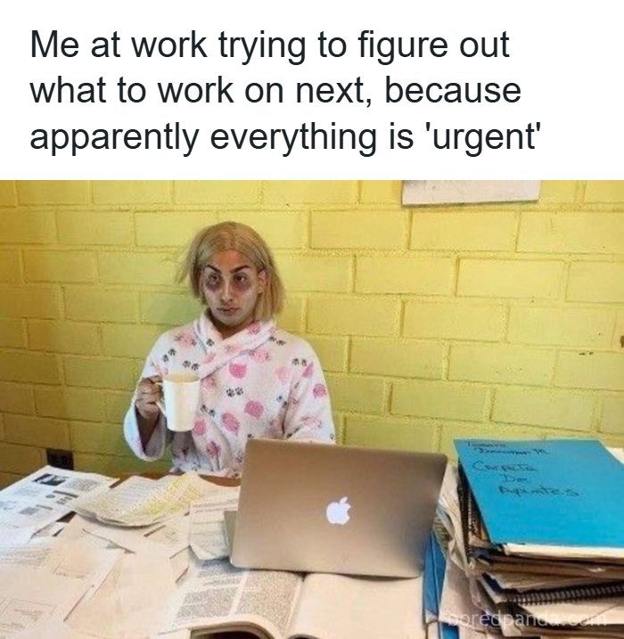 A Meme Queen image of a disheveled person at a messy desk with a laptop and coffee, illustrating the stress of urgent tasks at work.