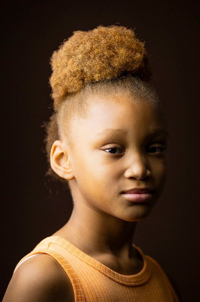 Young girl with an afro hairstyle, celebrating natural redheads, from the global portrait project.