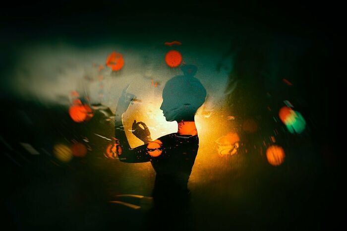A silhouette of a woman created with neon lights, capturing a cinematic portrait. Bokeh lights create an ethereal atmosphere.