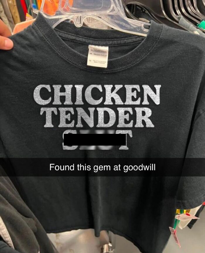 A black t-shirt with CHICKEN TENDER written in silver, with a redacted word below it, found at Goodwill, a brilliant t-shirt find.