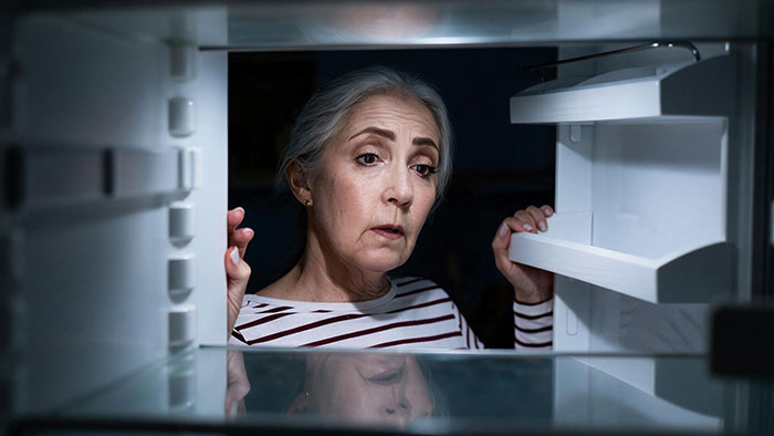 Image showing a hunter's mom looking into an empty fridge, having taken her share of meat. Image showing a hunter's mom looking into an empty fridge, having taken her share of meat.