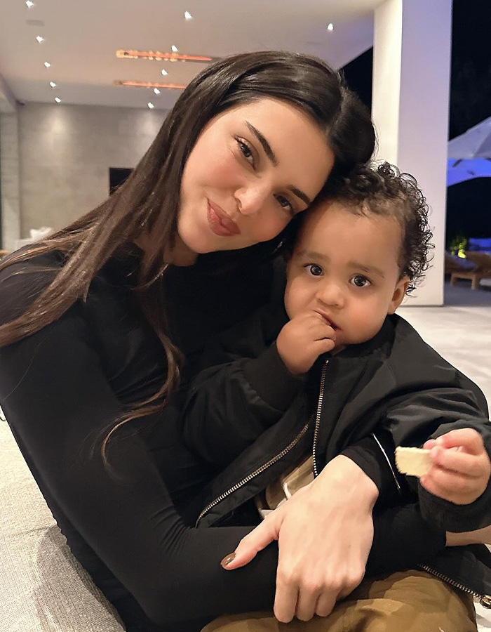 Kendall Jenner holding a baby, showcasing a softer side of Kendall Jenner amid romance rumors. Kendall Jenner holding a baby, showcasing a softer side of Kendall Jenner amid romance rumors.