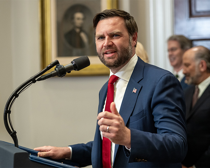 JD Vance at a podium, making a casual comment, with critics potentially noticing something that doesn't add up. JD Vance at a podium, making a casual comment, with critics potentially noticing something that doesn't add up.