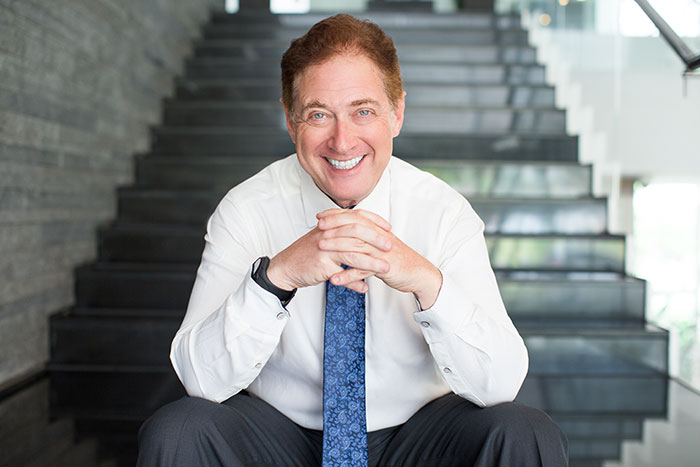 A smiling businessman in a white shirt and blue tie, embodying success in strange jobs.