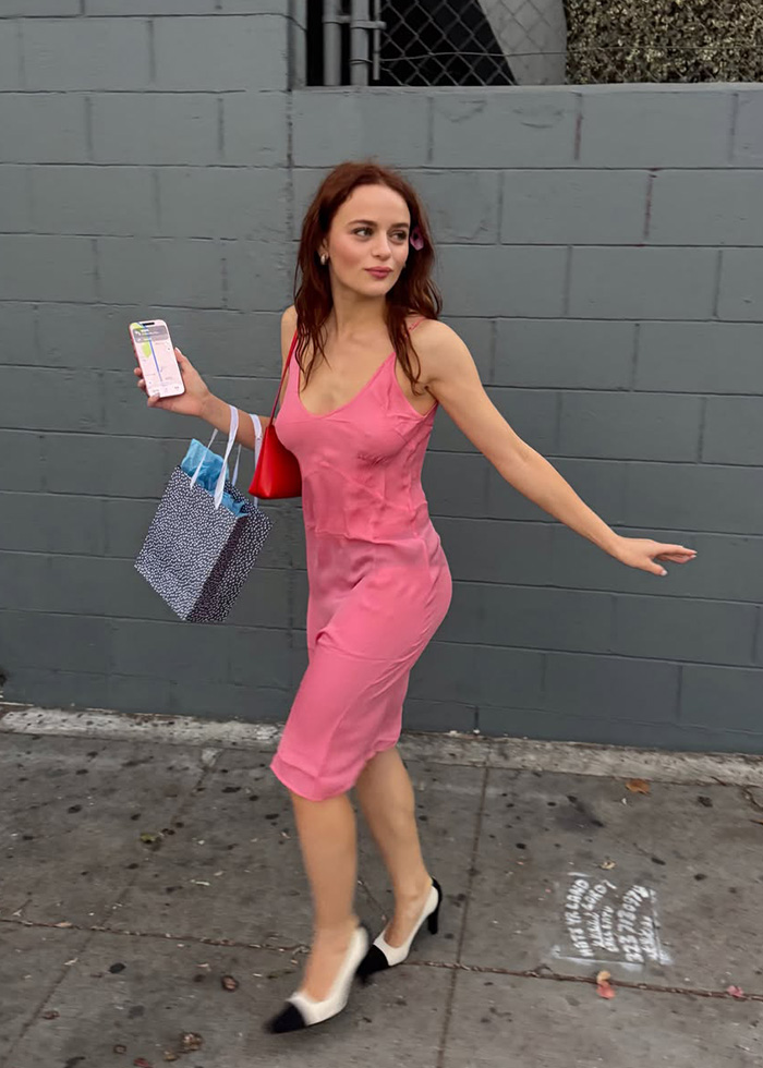 Joey King walks down a street, holding a phone and bag, sparking plastic surgery accusations. Joey King walks down a street, holding a phone and bag, sparking plastic surgery accusations.