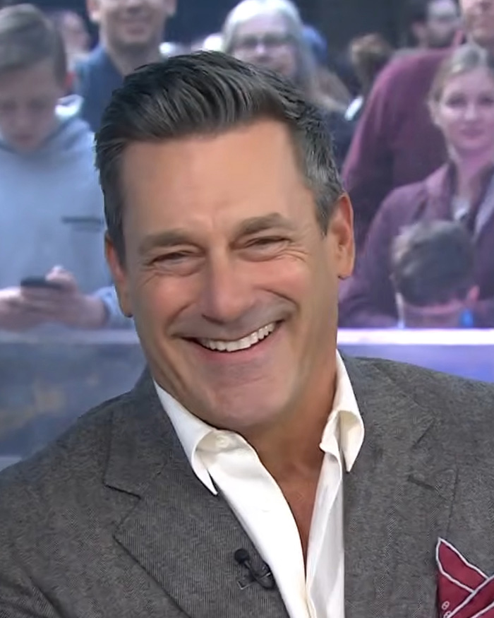 Close-up of Jon Hamm, expecting first child, smiling broadly in a gray jacket with a white shirt. Close-up of Jon Hamm, expecting first child, smiling broadly in a gray jacket with a white shirt.