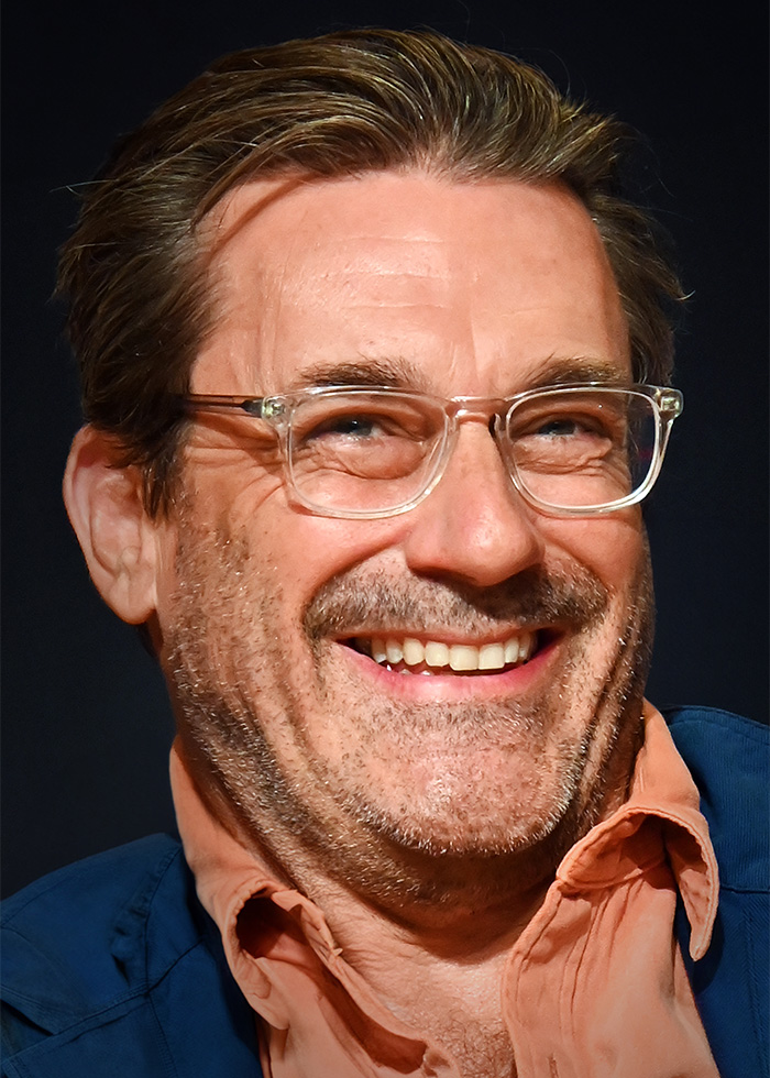 Close-up of Jon Hamm smiling, as fans express skepticism about Jon Hamm expecting his first child at his age. Close-up of Jon Hamm smiling, as fans express skepticism about Jon Hamm expecting his first child at his age.