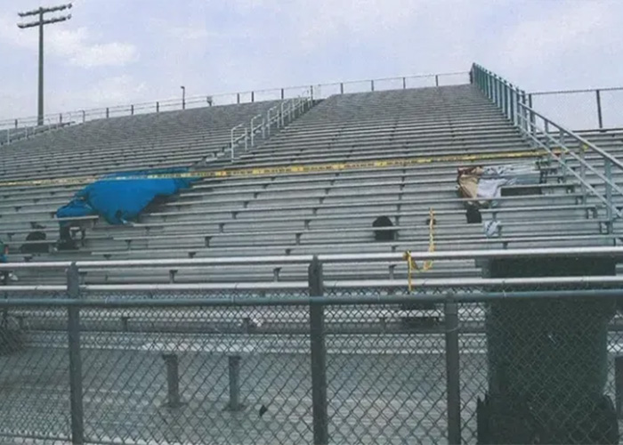 The crime scene at an empty stadium with police tape and a blue tarp, part of the Karmelo Anthony case evidence. The crime scene at an empty stadium with police tape and a blue tarp, part of the Karmelo Anthony case evidence.