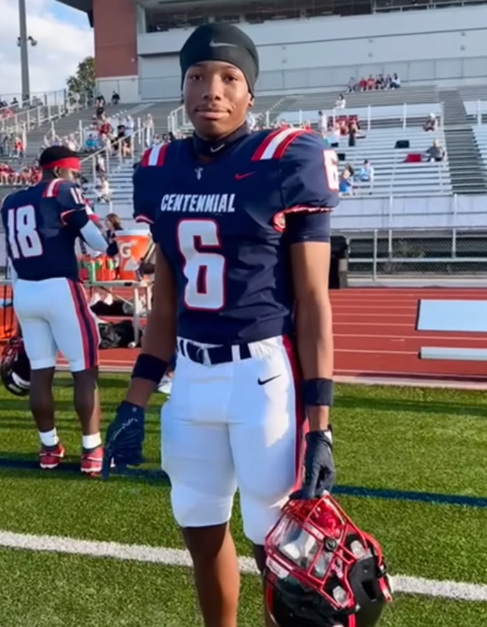 Karmelo Anthony, a young football player, in a Centennial High School uniform, holding his helmet. Karmelo Anthony, a young football player, in a Centennial High School uniform, holding his helmet.