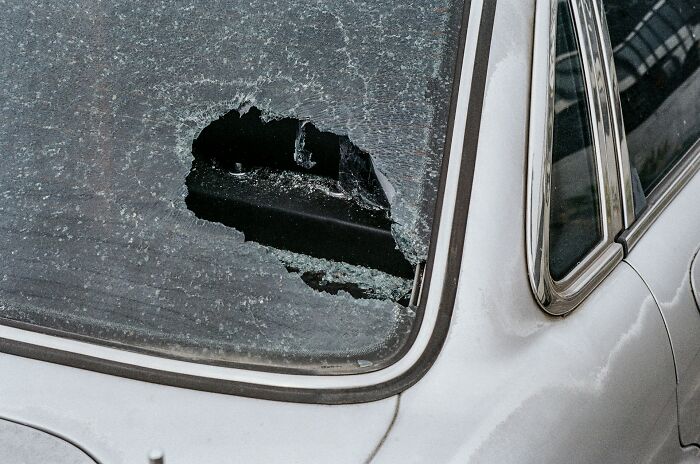 A shattered car window, representing one of the worst wedding moments that guests cant believe actually happened.